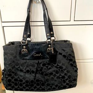 Black Coach tote...signature logo, multiple pockets and sections inside